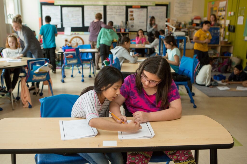 Fourth graders work together to plan life for their “colony” during a class activity focused on colonial America.
