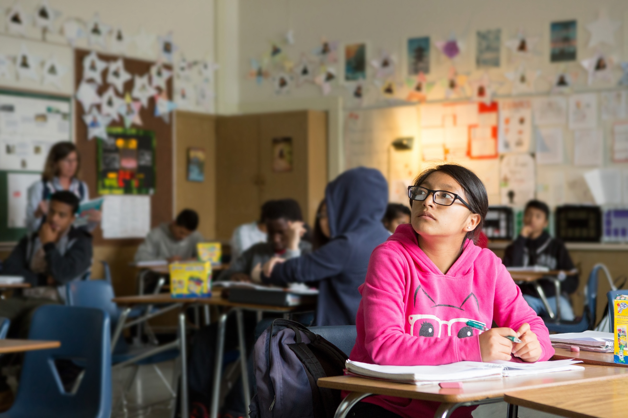 A student contemplates her response to a writing prompt in English class. **THIS IMAGE HAS BEEN DIGITALLY ALTERED TO REMOVE OR OBSCURE STUDENT IDENTITIES.**