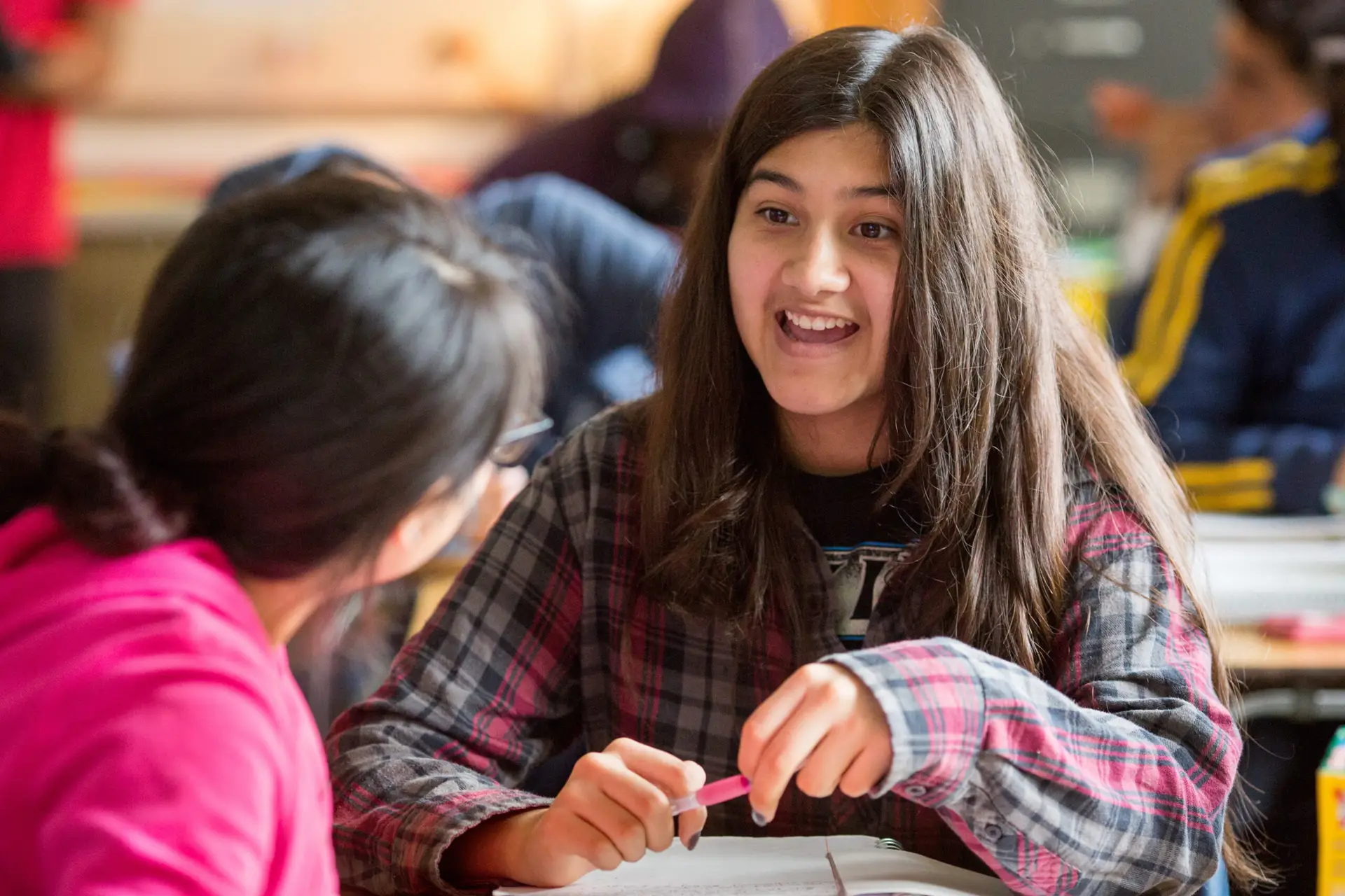 A student discusses examples of hyperbole in a high school English class.