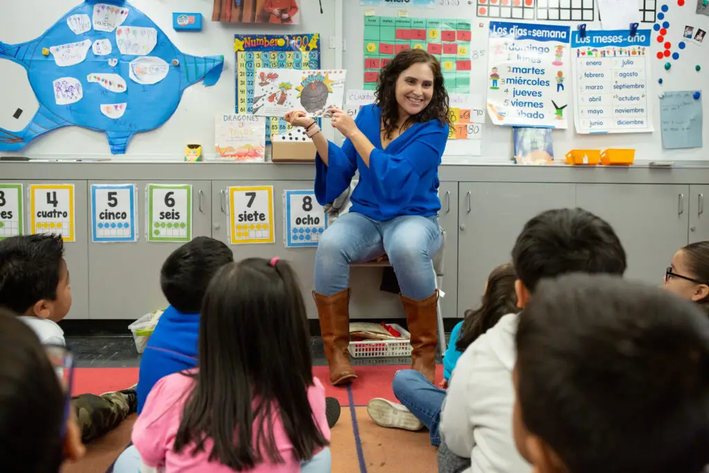 A teacher reads a story to her prekindergarten students.